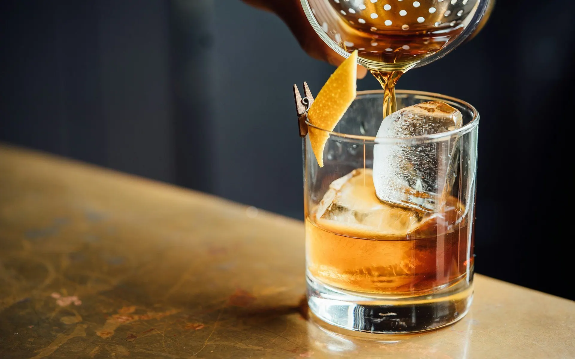 Cocktail being finished at a bar