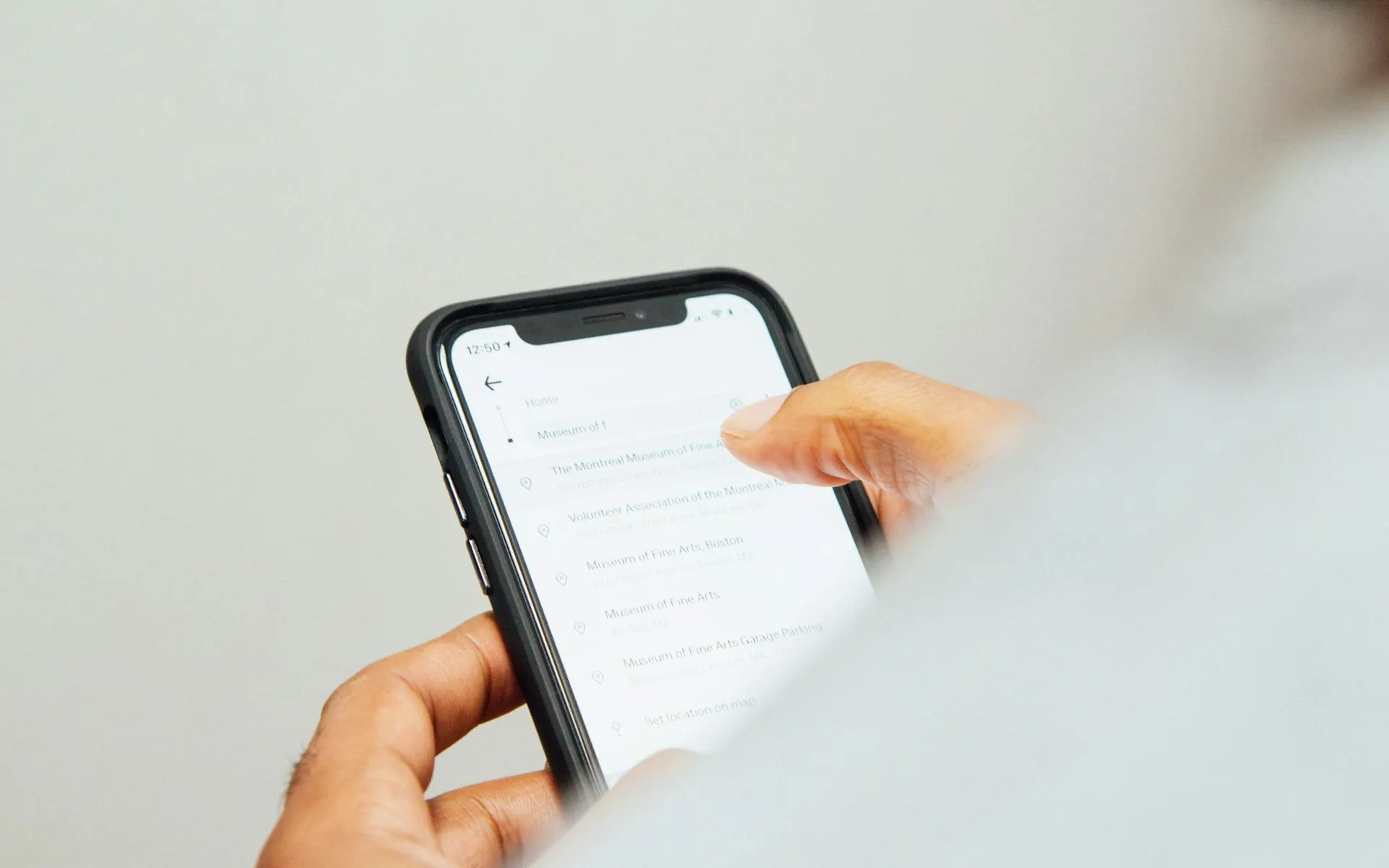 Hand holding a phone showing a list of notifications