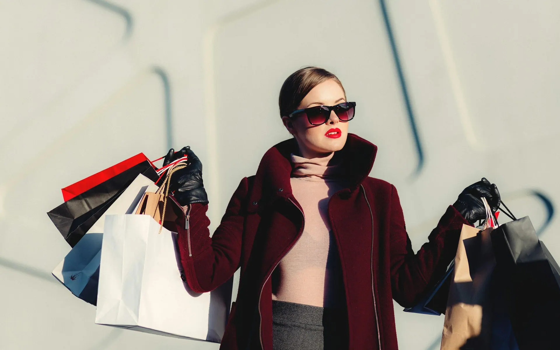 Shopper carrying several paper shopping bags