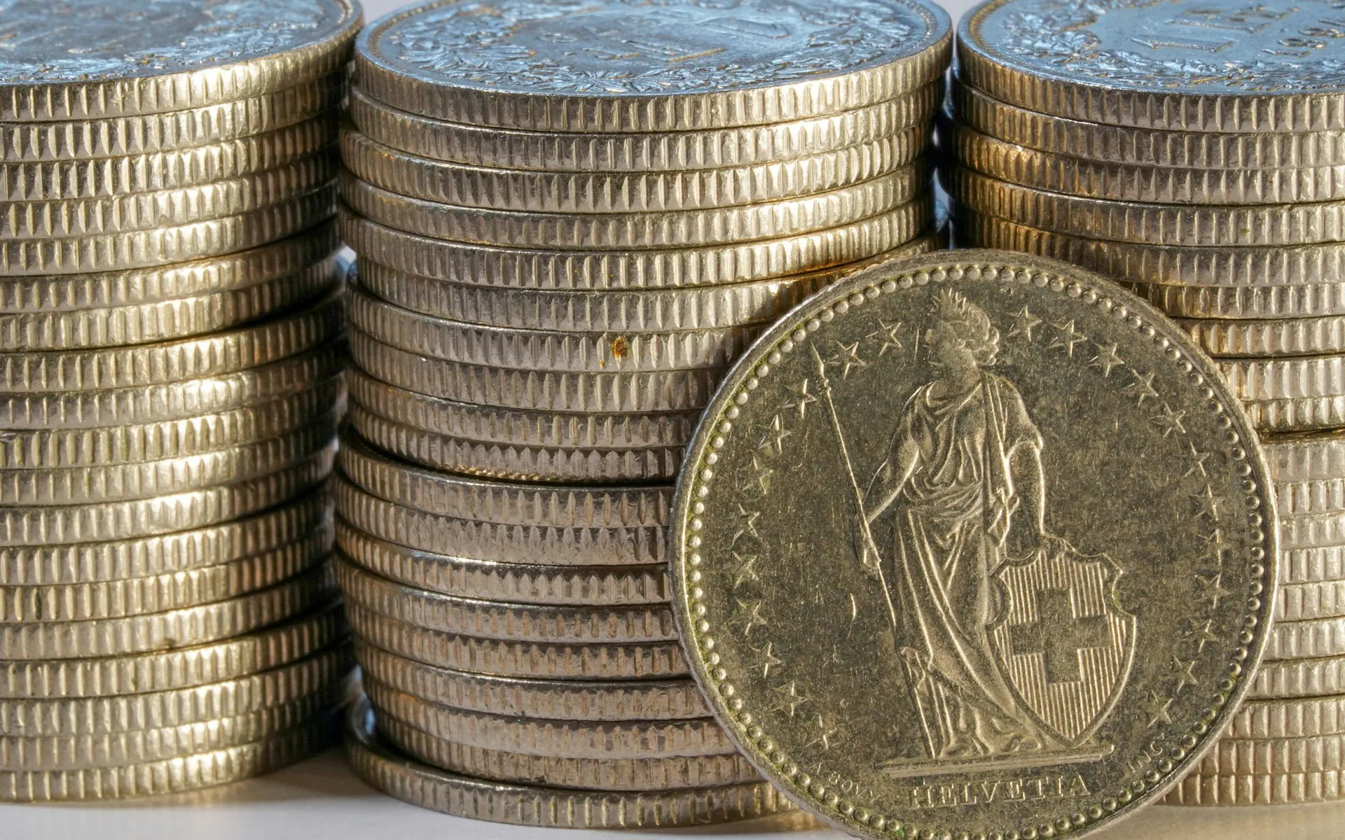 Stacks of coins on a neutral background